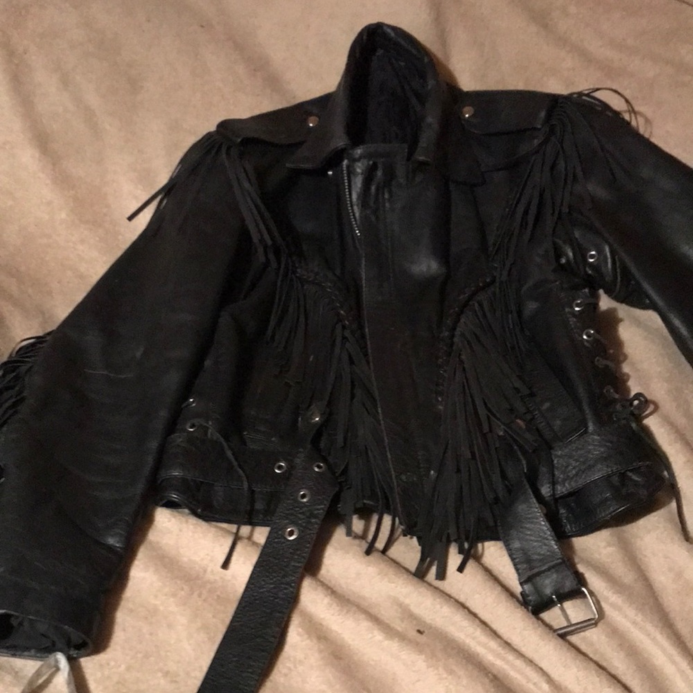 Vintage leather jacket with braided yolk and fringe.